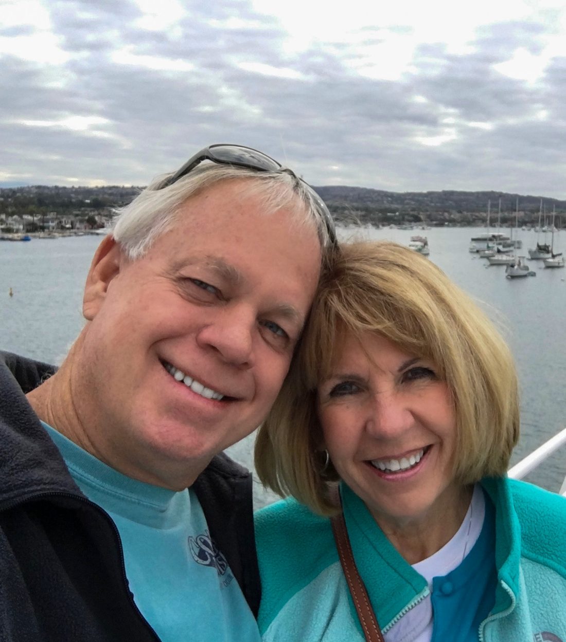 Rob and Pam Guthrie smiling together by the water